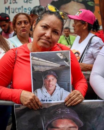 Eine Demonstrantin in Caracas zeigt das Foto eines in El Salvador inhaftierten Angehörigen
